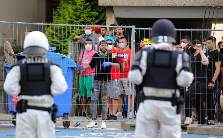 Police officers in Göttingen, Germany, face a group of residents quarantined inside a residential housing complex, June 20.