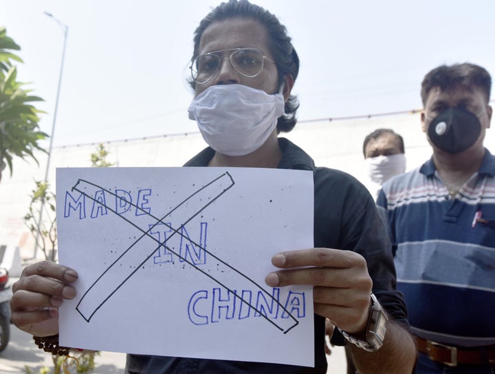 A protester holds up a poster as a group calls for boycott of Chinese manufactured products at Laxmi Nagar on June 18, 2020 in New Delhi, India.