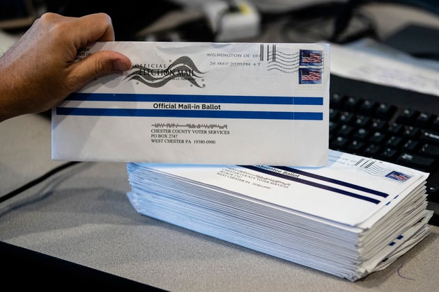 An election worker in West Chester, Pennsylvania, processes mail-in ballots on May
