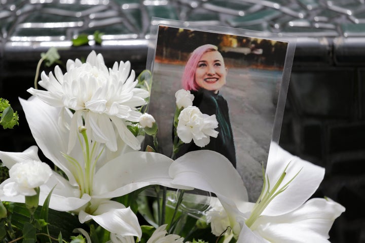 A photo of Summer Taylor, who suffered critical injuries and died after being hit by a car while protesting over the weekend, sits among flowers at the King County Correctional Facility.