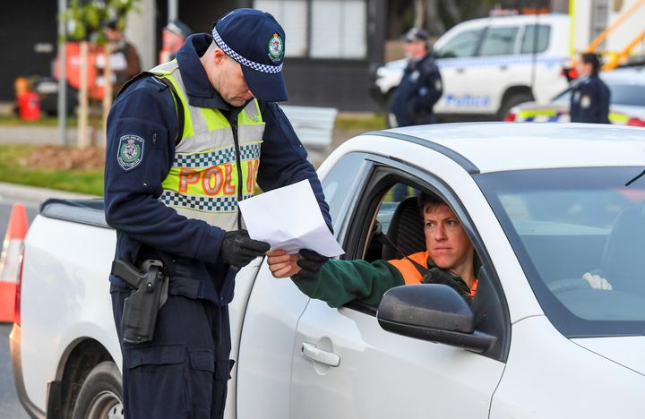 Police in the southern New South Wales (NSW) border city of Albury check cars crossing the state border from Victoria on July 8, 2020 (Photo by WILLIAM WEST/AFP via Getty Images)