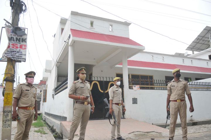 Police officials stand guard outside gangster Vikas Dubey's house at Krishna Nagar on July 3, 2020 in Lucknow.