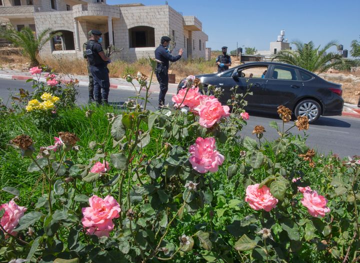 A Palestinian security unit mans a checkpoint at an entrance of in the West Bank city of Ramallah on July 2. The Palestinian Authority, which governs parts of the Israeli-occupied West Bank, is grappling with a renewed coronavirus outbreak that authorities blame on the summer wedding season. 