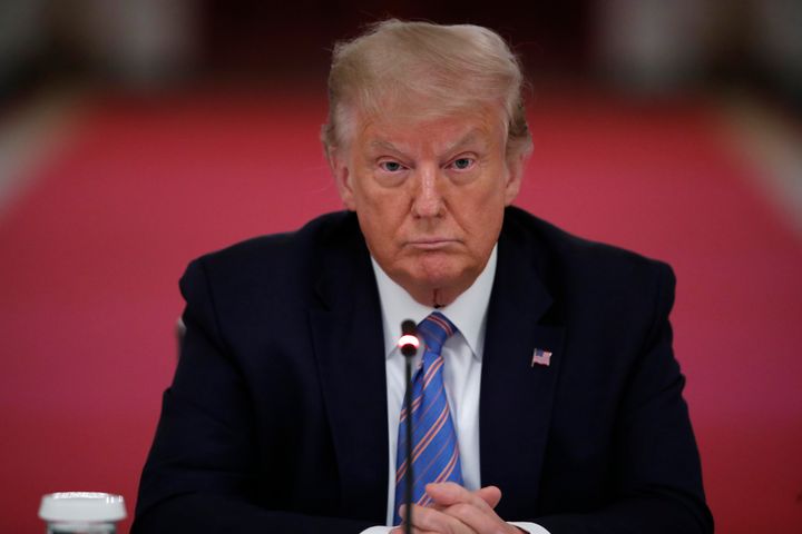 President Donald Trump listens during a "National Dialogue on Safely Reopening America's Schools" at the White House on Tuesday. He has said he will pressure states and local governments to open schools in the fall. 
