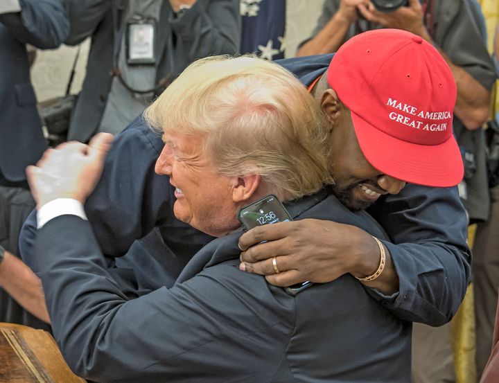 Kanye West and Donald Trump embracing in the Oval Office