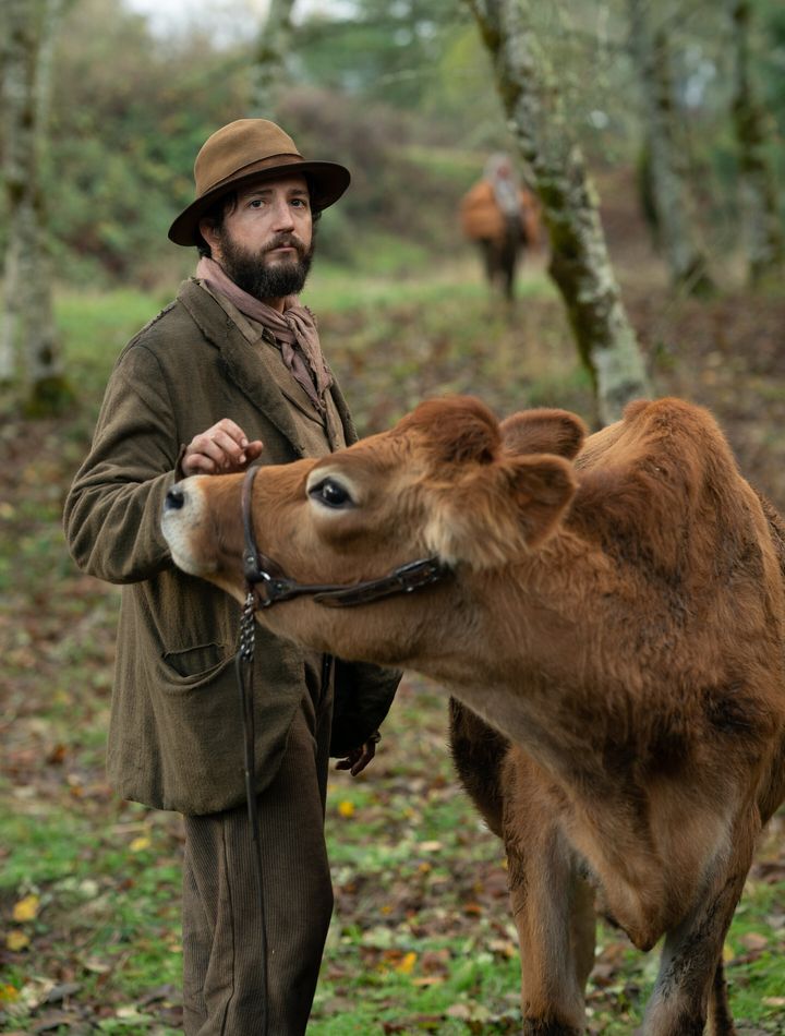Eve the cow (seen here with John Magaro) makes her screen debut in "First Cow."