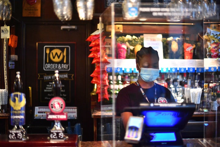 Bar staff waits for customers at the Rochester Castle pub in Stoke Newington, north London, as coronavirus lockdown restrictions are eased across England.