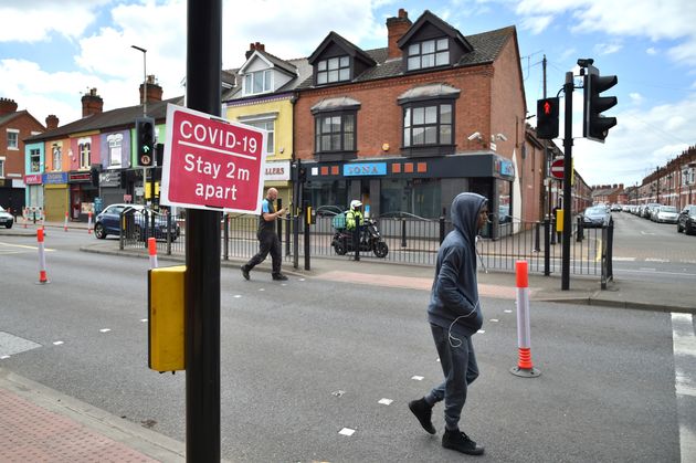 People walk in Melton Road also known as the Golden Mile in Leicester