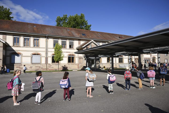 Children line up to enter their classrooms at an elementary school in Strasbourg, France. Primary and middle schools in the country reopened on June 22.