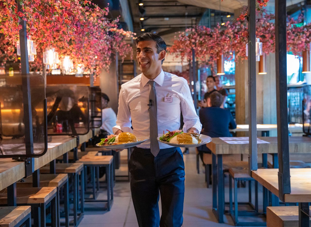 Chancellor Rishi Sunak serving customers at a Wagamama restaurant in central London after unveiling his "eat out to help out" scheme.