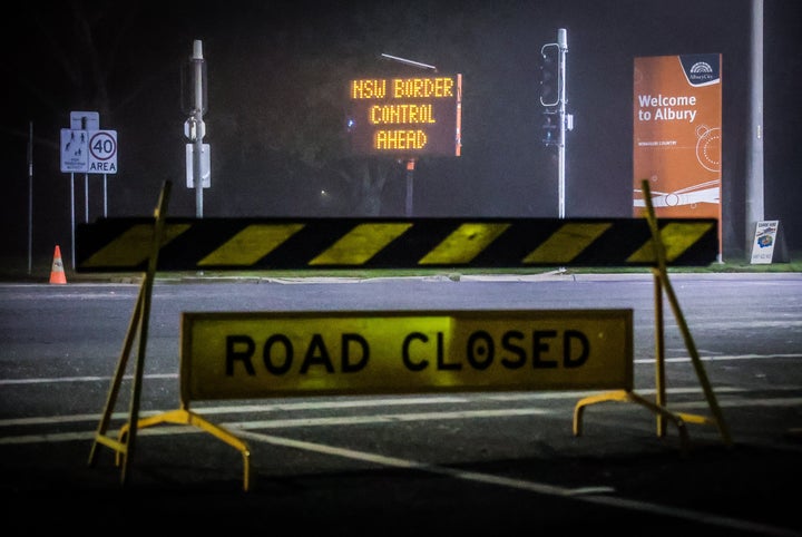 Road signs are displayed near a police checkpoint on July 8, 2020 in Albury, Australia. (Photo by David Gray/Getty Images)