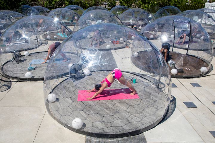 People participate in an outdoor yoga class by LMNTS Outdoor Studio, in a dome to facilitate social distancing and proper protocols to prevent the spread of COVID-19 in Toronto on June 21, 2020.