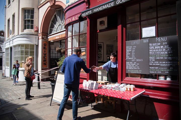 A cafe in London serves take away, April 15. The hospitality and retail industries have been hit particularly hard by the pandemic.