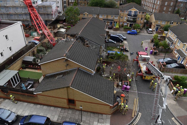 The scene in Bow where a 20-metre crane collapsed on to a property leaving people trapped inside, in east London, Wednesday.