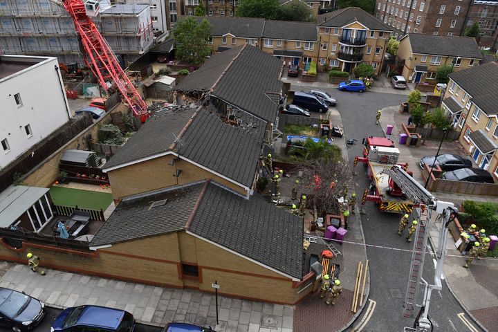 The scene in Bow where a 20-metre crane collapsed on to a property leaving people trapped inside, in east London, Wednesday.