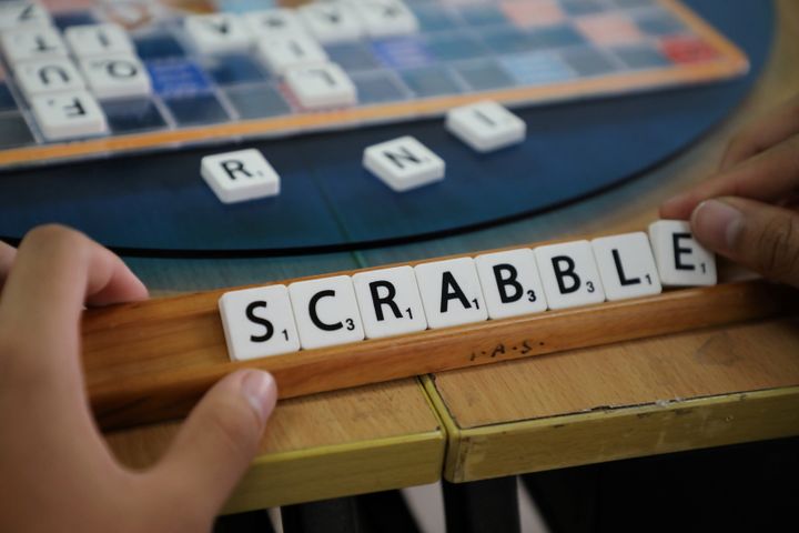 A player forms the word "Scrabble" with tiles during a practice session in Kuala Lumpur on Nov. 30, 2019. Organizers are debating whether slurs should be accepted for use in the game. 