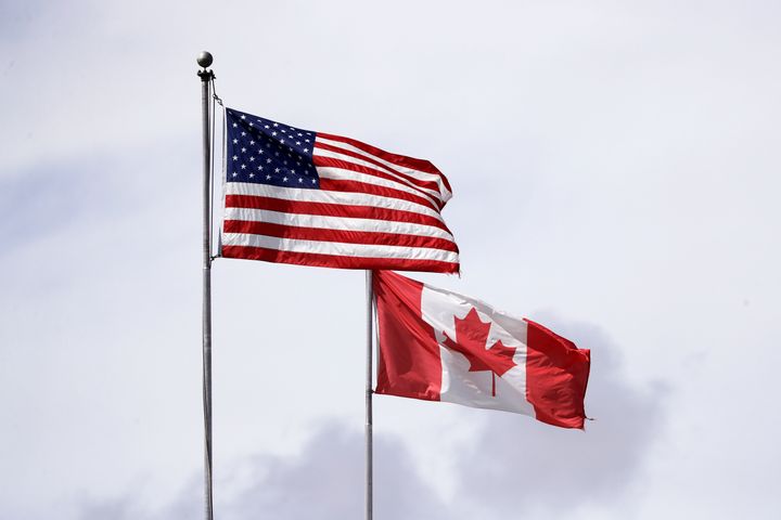 U.S. and Canadian flags fly atop the Peace Arch in B.C. at the Canada-U.S. border on May 17, 2020.