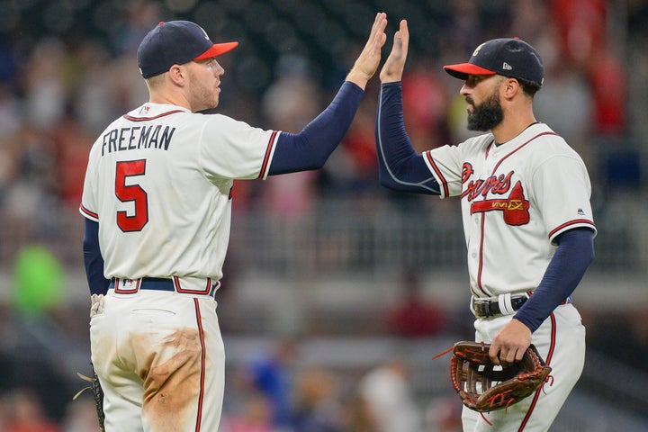 After Atlanta Braves first baseman Freddie Freeman (left) tested positive for COVID-19, rightfielder Nick Markakis (right) decided to sit out the 2020 season -- a decision a growing number of baseball players have made.