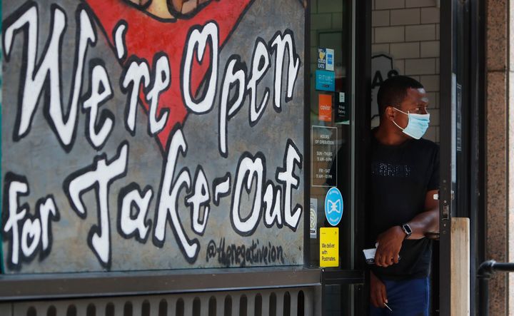 Amid concerns about the spread of COVID-19, a food delivery driver wears a mask at a restaurant in downtown Dallas on July 8.