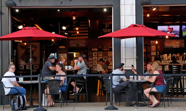 People eat inside and outside at a Pittsburgh restaurant on June 28. The WHO noted multiple reported outbreaks of COVID-19 involving those who became infected after being in crowded indoor spaces, including restaurants, fitness classes and choir practice.