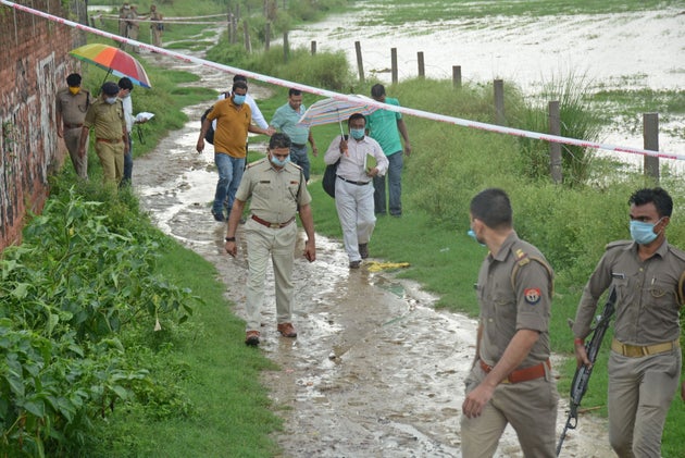 Policemen arrive at the scene to investigate after gangster Vikas Dubey was shot dead by police in Uttar...