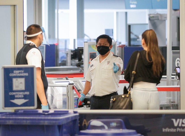 Border officers are seen wearing masks and a face shield at a security screening of Vancouver International Airport in Vancouver, British Columbia, Canada, on June 18, 2020. 