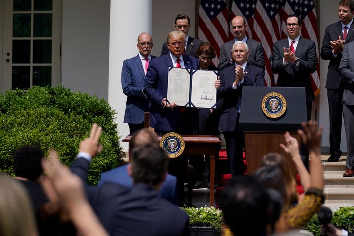 President Donald Trump poses for a photo after signing the Paycheck Protection Program Flexibility Act during a news conference in the Rose Garden of the White House on June 5, 2020.