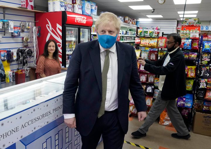 The PM in face mask as he visited businesses in Uxbridge on Friday and urged people to "be sure to follow the guidelines on social distancing".