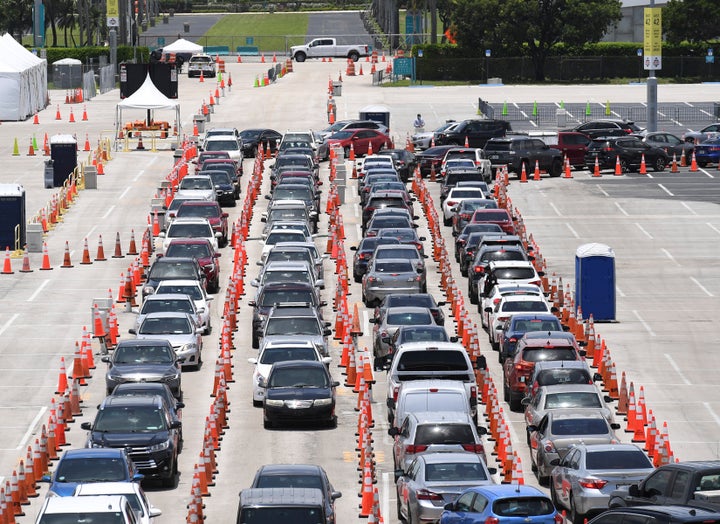 Cars wait in line at the coronavirus (COVID-19) drive up testing site set up at the Miami Beach Convention Center as Florida