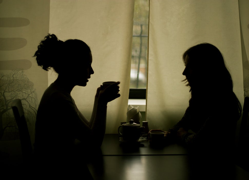 Silhouettes of Two Women Drinking Tea in Cafe