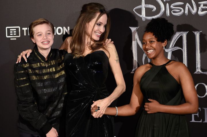 Angelina Jolie and her children Shiloh Jolie-Pitt (left) and Zahara Jolie-Pitt at a premiere in 2019. 