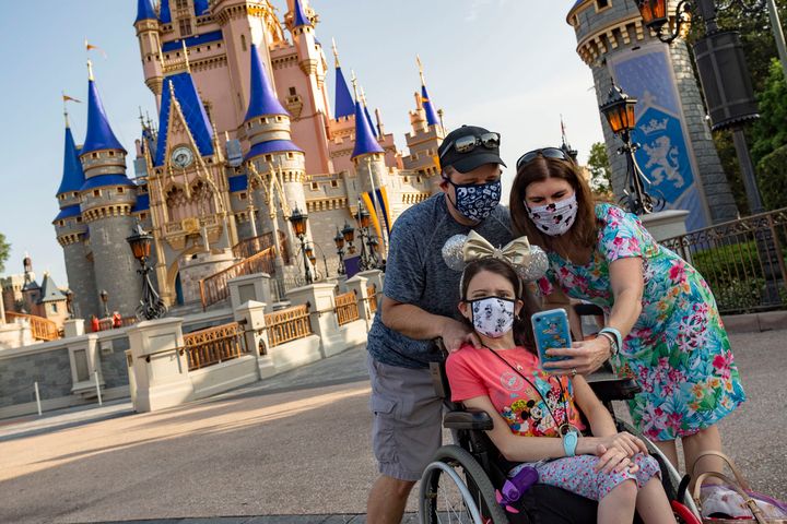 Visitors take a selfie at Magic Kingdom Park at Walt Disney World Resort on July 11, 2020 in Lake Buena Vista, Florida