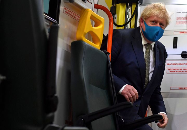 Prime minister Boris Johnson boards an ambulance during a visit to the headquarters of the London Ambulance Service NHS Trust in London