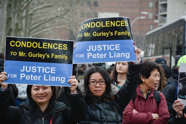 Women raising posters during a rally in support of NYPD ex-cop Peter Liang in Brooklyn, New York City. The case created a big division within the Chinese community.