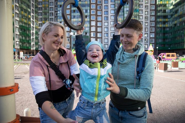 Irina and Anastasia Lagutenko play with their son, Dorian, at a playground in St. Petersburg, Russia, on July 2, 2020. 