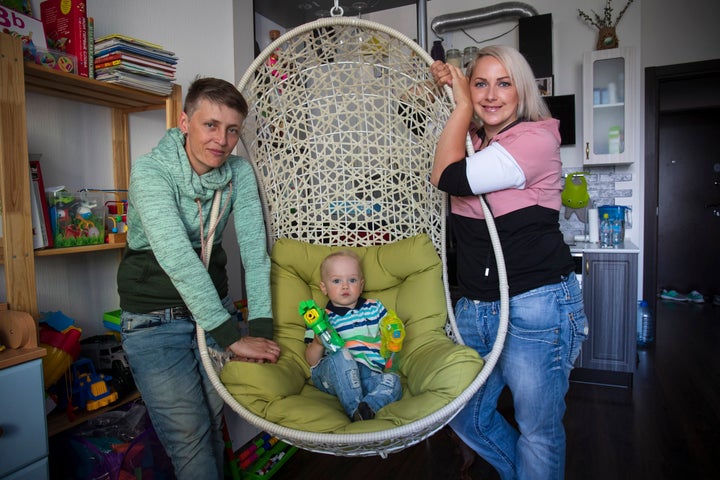 Irina, right, and Anastasia Lagutenko pose with their son, Dorian, in St. Petersburg, Russia, on July 2, 2020. Their 2017 wedding was not legally recognized in Russia. 