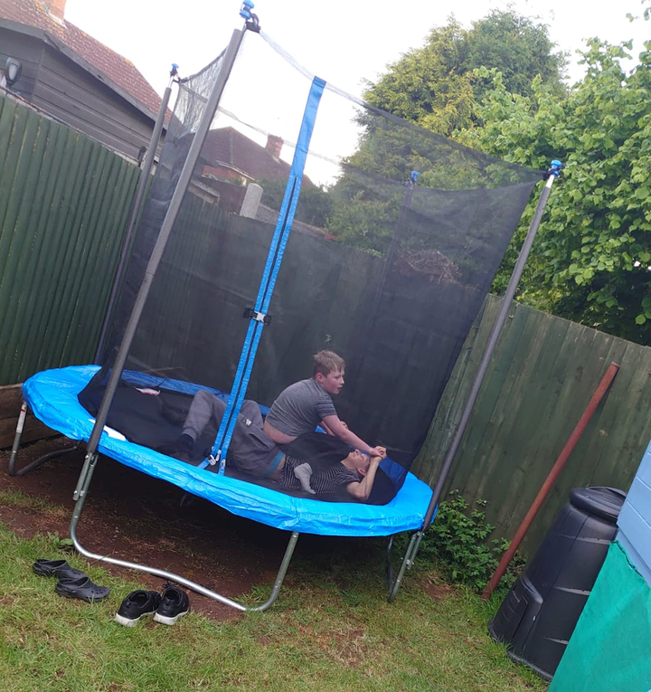 Stanley and Nathan playing on the trampoline provided by Action for Children