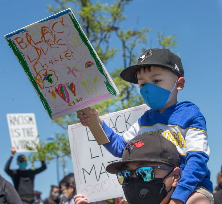 A young boy carries a homemade sign during a Black Lives Matter march in Markham, Ont.