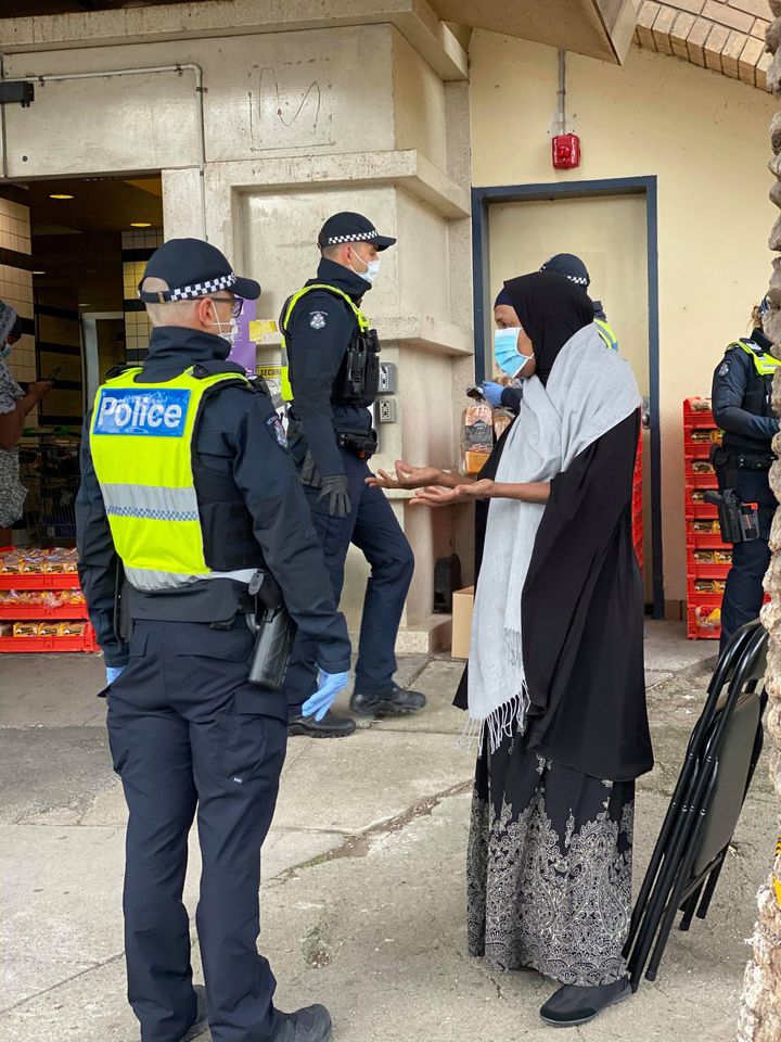 Community leader Fartun Farah negotiates access with police in order to provide support to residents locked in the Flemington public housing block last week. 
