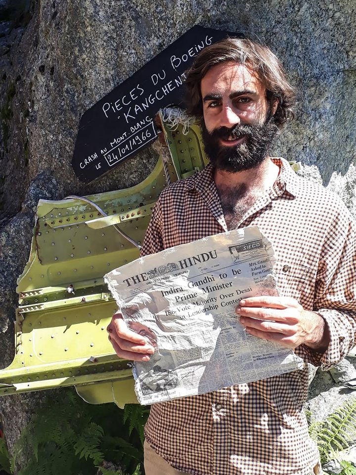 Thimotee Mottin, manager of the cafe-restaurant Cabane du Cerro near the Bossons glacier, poses on July 9, 2020, at his cafe near Chamonix in the French Alps, holding a 1966 copy of Indian newspaper The Hindu.