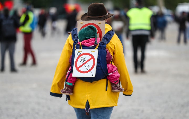 A protester at rally in Stuttgart, Germany, wears a sign signaling opposition to a coronavirus vaccine, May 2, 2020.