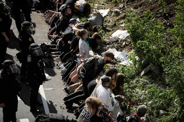 FILE—In this file photo from June 1, 2020, police detain protesters along Interstate 676 in Philadelphia in the aftermath of a march calling for justice over the death of George Floyd.