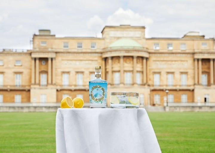 A bottle of the official Buckingham Palace gin in front of the palace. The Queen prefers hers with a slice of lemon and two ice cubes mixed with Dubonnet.