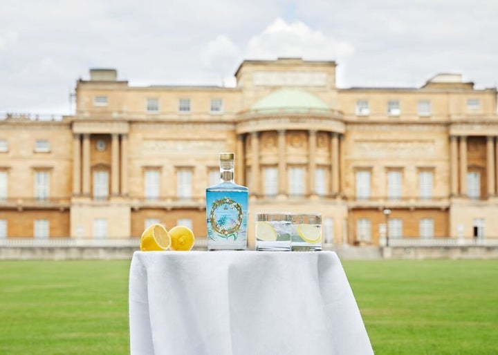 A bottle of the official Buckingham Palace gin in front of the palace. The Queen prefers hers with a slice of lemon and two ice cubes mixed with Dubonnet. 