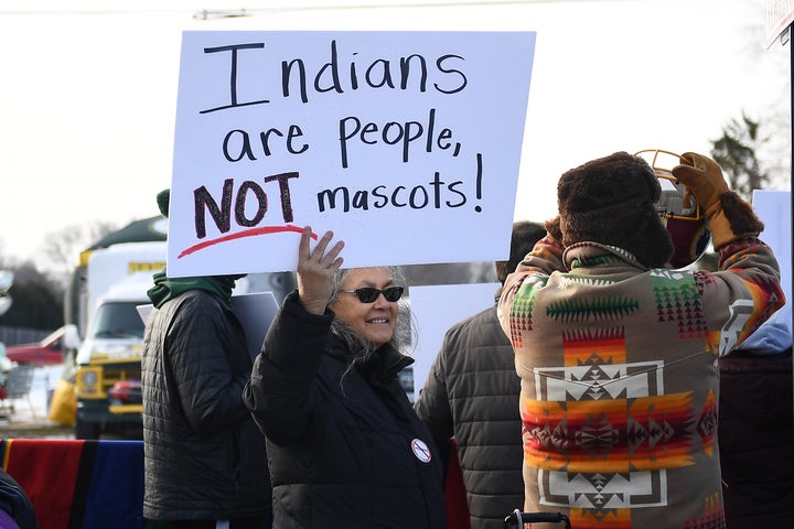 A woman demonstrates against the Washington team name outside a game in Green Bay, Wisconsin, in 2019. The franchise has often faced protests outside road games, especially as pressure to change its name intensified again over the last decade.