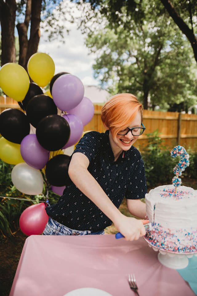 Grey cutting the cake at his gender reveal.