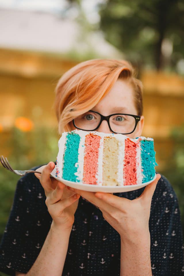 Grey with the cake in the colour of the transgender flag at his gender-reveal party.