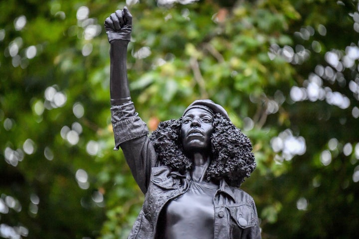 A black resin and steel statue titled "A Surge of Power (Jen Reid)" 2020, by Marc Quinn is installed on the vacant Edward Colston plinth in Bristol city center.