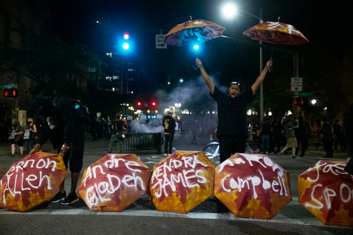 Umbrellas bearing the names of people killed by police were displayed at SW 3rd and Main as Portland protesters gather downtown on July 10, 2020.