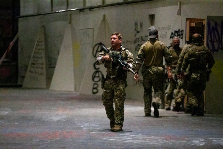 Federal officers pull a protester into the Federal Courthouse on July 10, 2020, as protesters gather in downtown Portland.